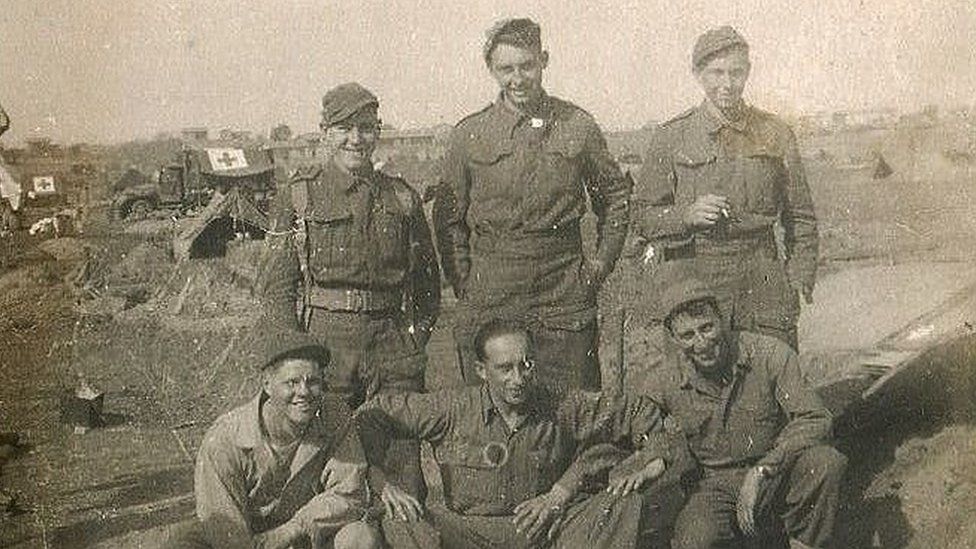 Walter Nixon as a young man in army uniform with five comrades in the field