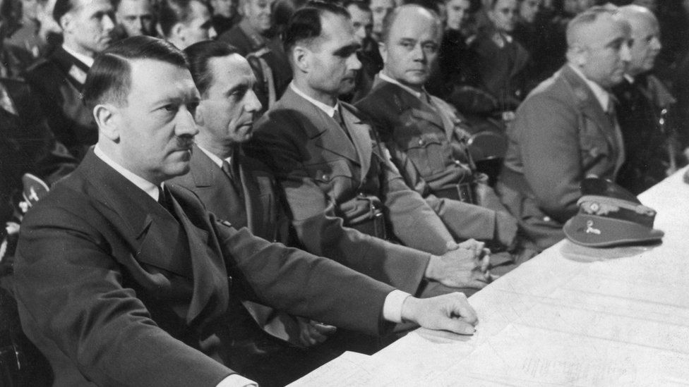30th January 1941: L-R: German dictator Adolf Hitler (1889 - 1945), Minister of Propaganda Joseph Goebbels (1897 - 1945), Nazi deputy Rudolf Hess (1894 - 1987), Dr. Robert Ley (1890 - 1945), SS leader Hans Lammers (1879 - 1962) and an unidentified man sit at a table during a Nazi Party gathering at the Berlin Sports palace on the eighth anniversary of Hitler's chancellorship of Germany.