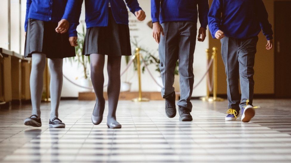 School children walking along a corridor