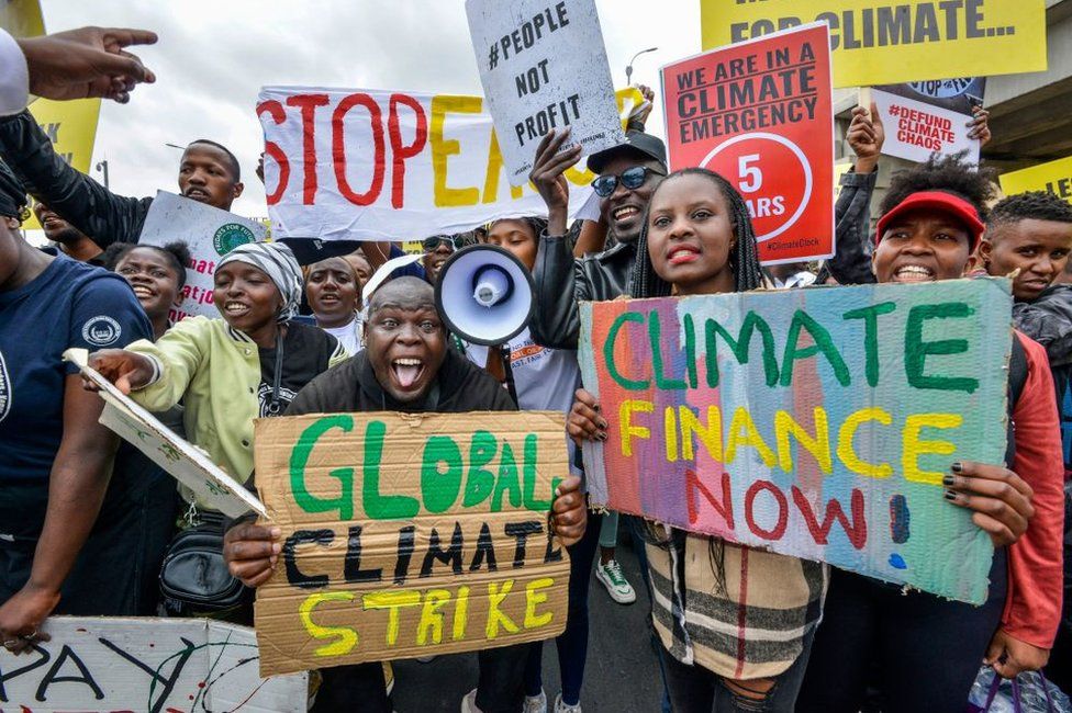 Climate activists holding placards in Nairobi, 4 September