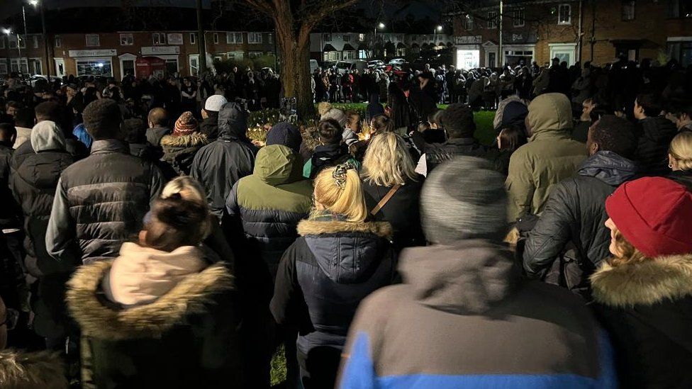 People attending a vigil in Sea Mills