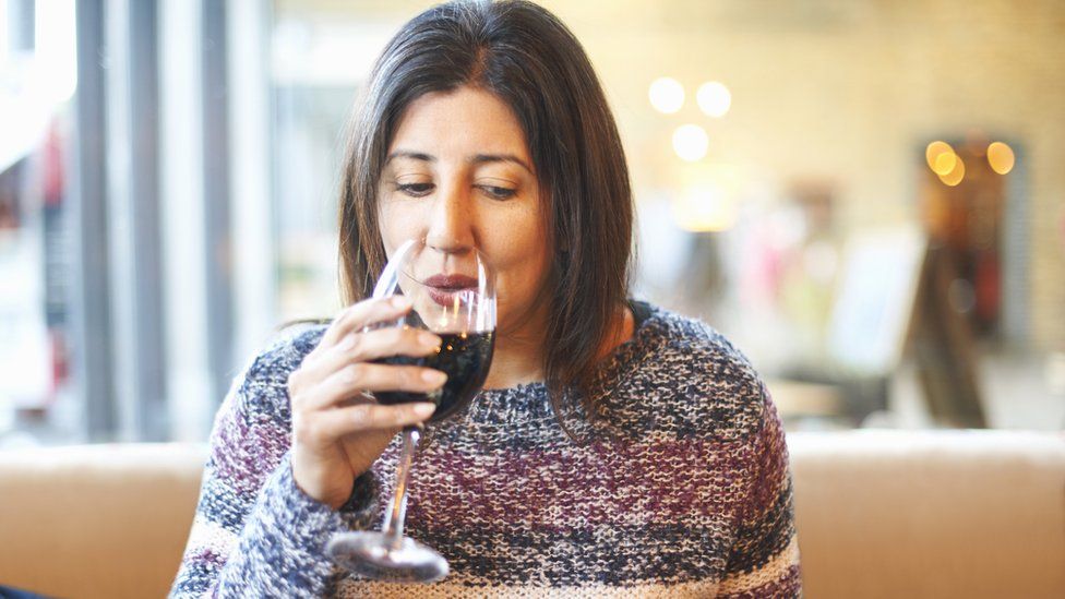 Woman drinking glass of red wine