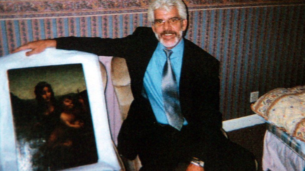 Undated defence handout picture, of private investigator Robert Graham holding the Leonardo da Vinci painting Madonna of the Yarnwinder.