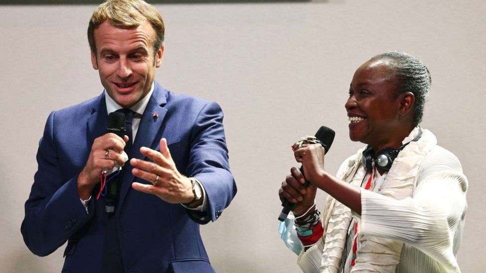 Cameroonian-born curator Koyo Kouoh (R) and French President Emmanuel Macron speak at a conference about the restitution of African heritage at the Africa-France summit in Montpellier, France 8 October 2021