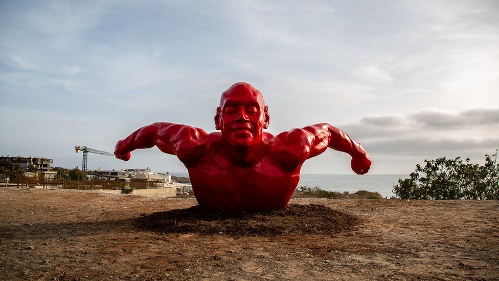 Diadji Diop's sculpture of a red swimmer.