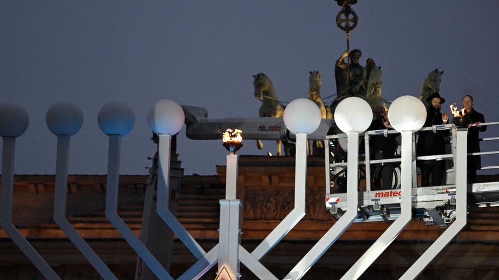 Rabbi Yehuda Teichtal and German Chancellor Olaf Scholz light the giant Menorah candelabrum, set up for the traditional Jewish Hanukkah (Chanukah) Festival of Lights, in Berlin at the Brandenburg Gate on December 7, 2023