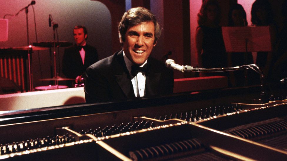 American singer and pianist Burt Bacharach performs with his piano circa 1968 in Los Angeles