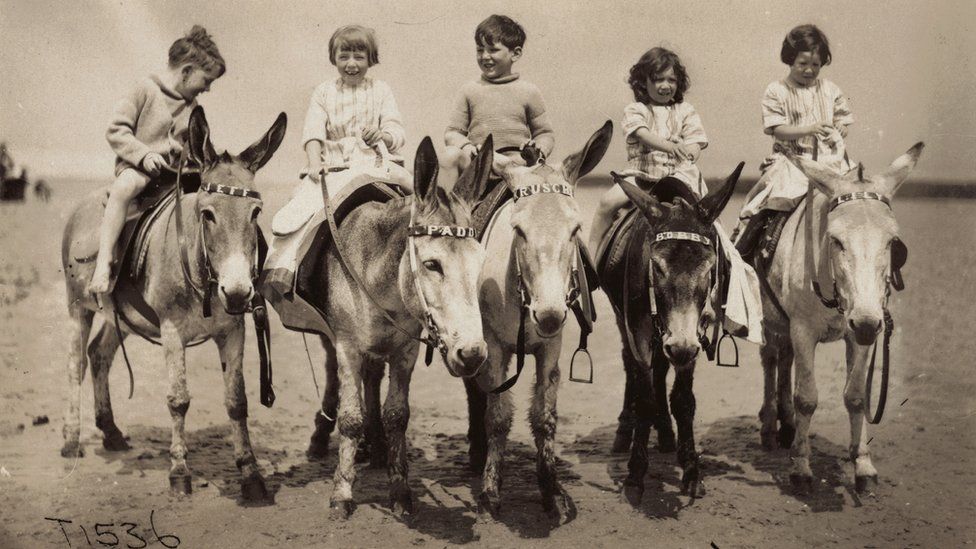 A typical seaside scene from the 1920s of children riding donkeys. My mother is on 