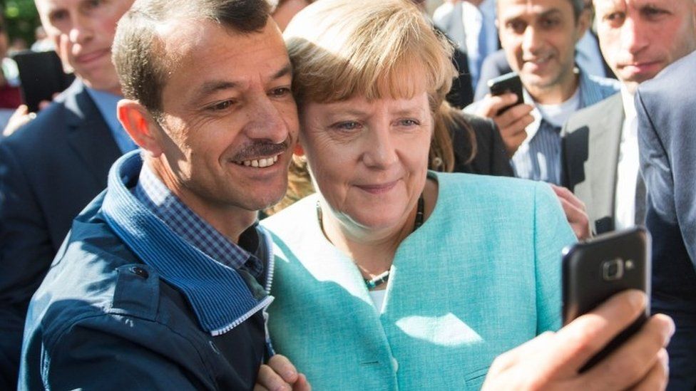 Chancellor Merkel with asylum seeker in Germany