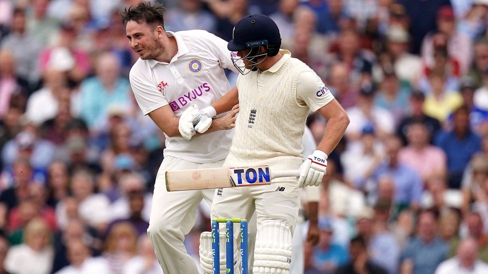 A man collides with England batsman Jonny Bairstow