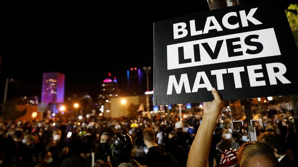 A demonstrator holds up a "Black Lives Matter" sign during a protest over the death of black man Daniel Prude, after police put a spit hood over his head during an arrest on March 23, in Rochester, New York, U.S. September 6, 2020
