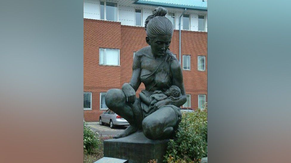 A statue of a mother holding a baby outside Liverpool Women's Hospital