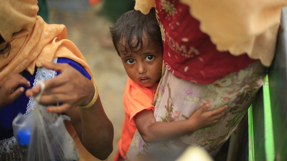 Two-year-old Hazera, confused and scared, holds on to her mother after reaching Bangladesh from Myanmar