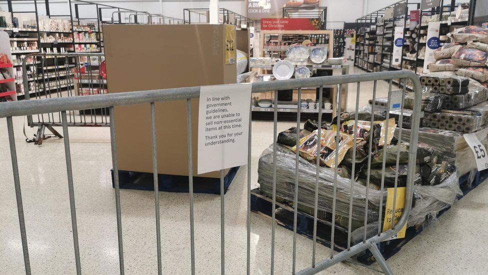 A notice informing customers of the sales of non-essential products at a Tesco Extra store in Pengam Green, Wales