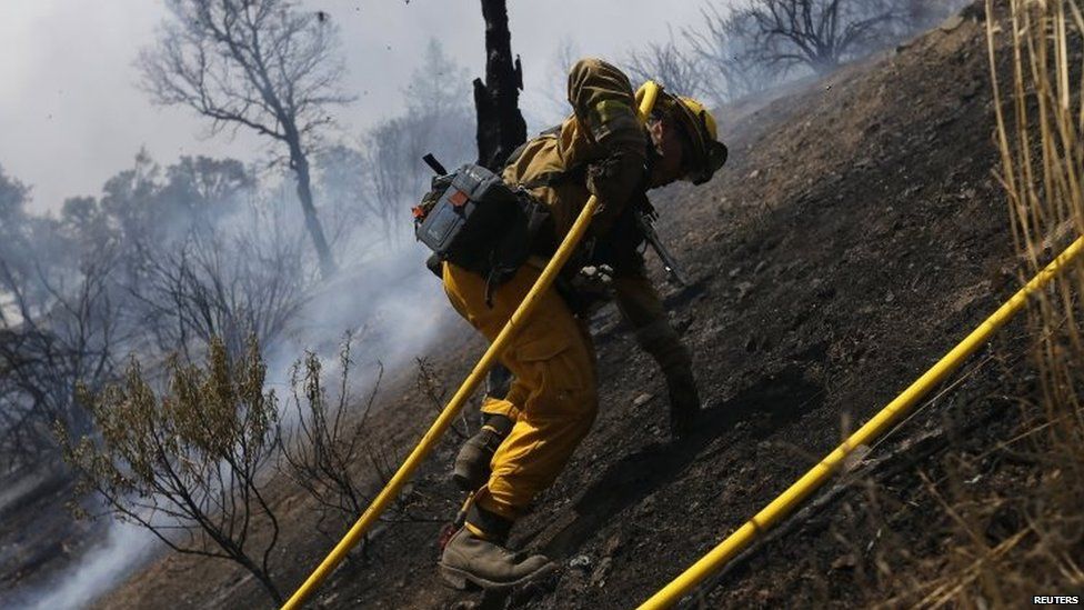 A fire fighter climbs a steep hill as he battles the Rocky fire near Lower Lake, California (03 August 2015)