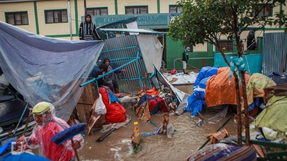 People recover their belongings during flooding caused by heavy rains in Sucre, Bolivia January 4, 2021.