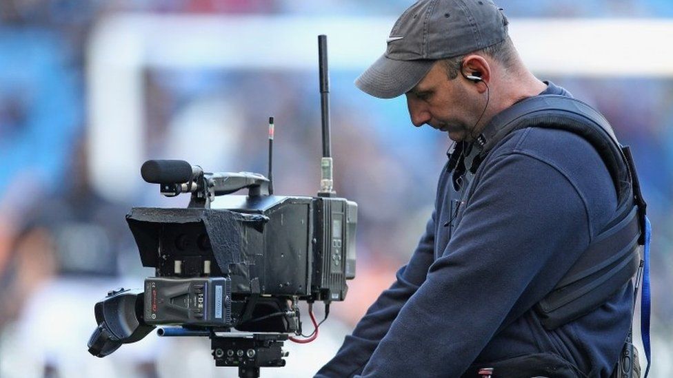 Cameraman at English Premier League match