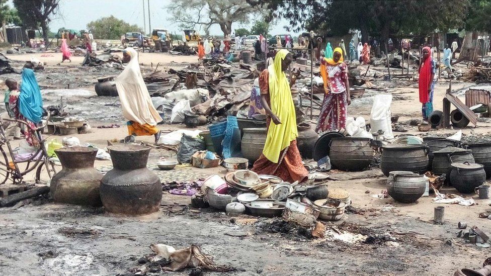 omen sift through the remains of a market blown up during an attack on September 20, 2018, in Amarwa, some 20 kilometres (12 miles) from Borno state capital Maiduguri.