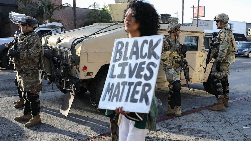 Protester next to National Guard unit in Los Angeles, 31 May 20