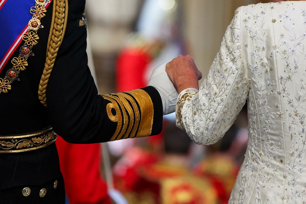 Britain's King Charles holds hands with Queen Camilla while walking after he delivered a speech at the State Opening of Parliament at the Houses of Parliament in London, Britain, November 7, 2023.
