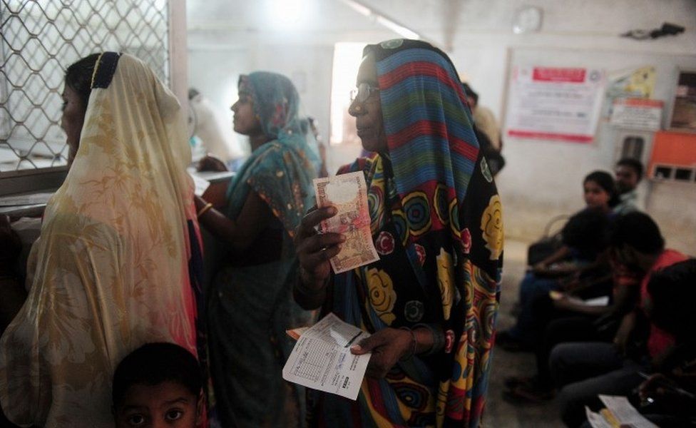Indian people queue inside a bank to deposit 500 and 1000 Indian rupee notes in Rahimapur village on the outskirts of Allahabad on November 10, 2016.