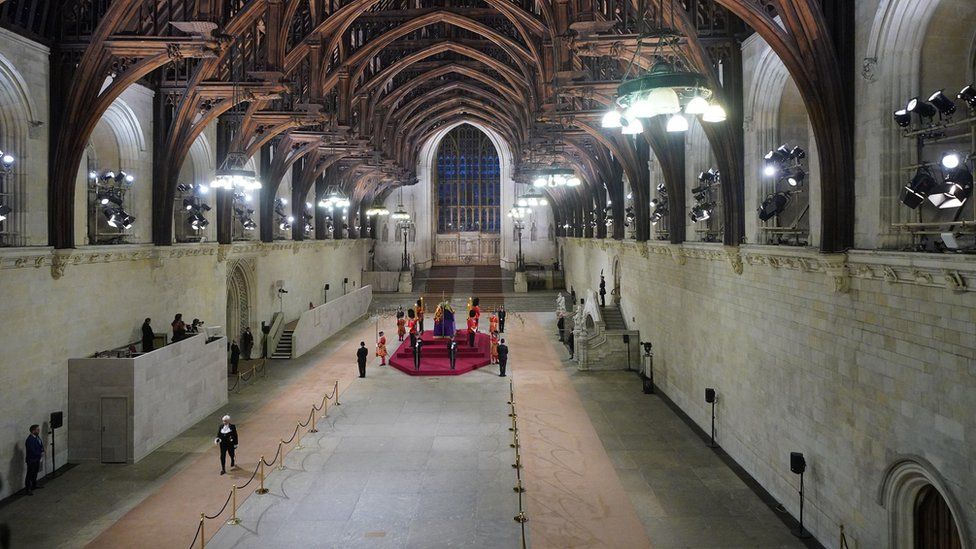 Black Rod walks through a near empty Westminster Hall at the end of the Queen's lying-in-state
