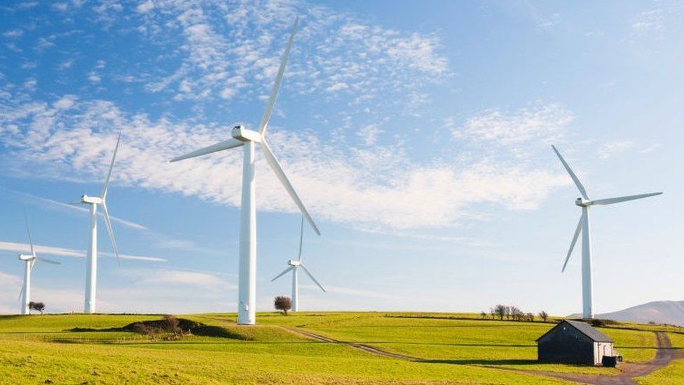 A wind farm on the outskirts of the Lake District with Skiddaw behind, Cumbria