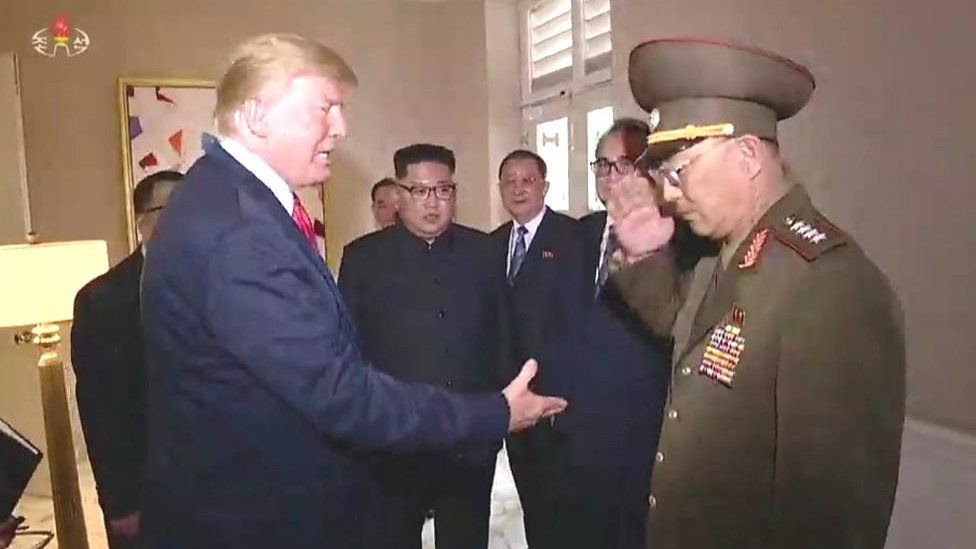 Trump, Kim and a member of the North Korean military