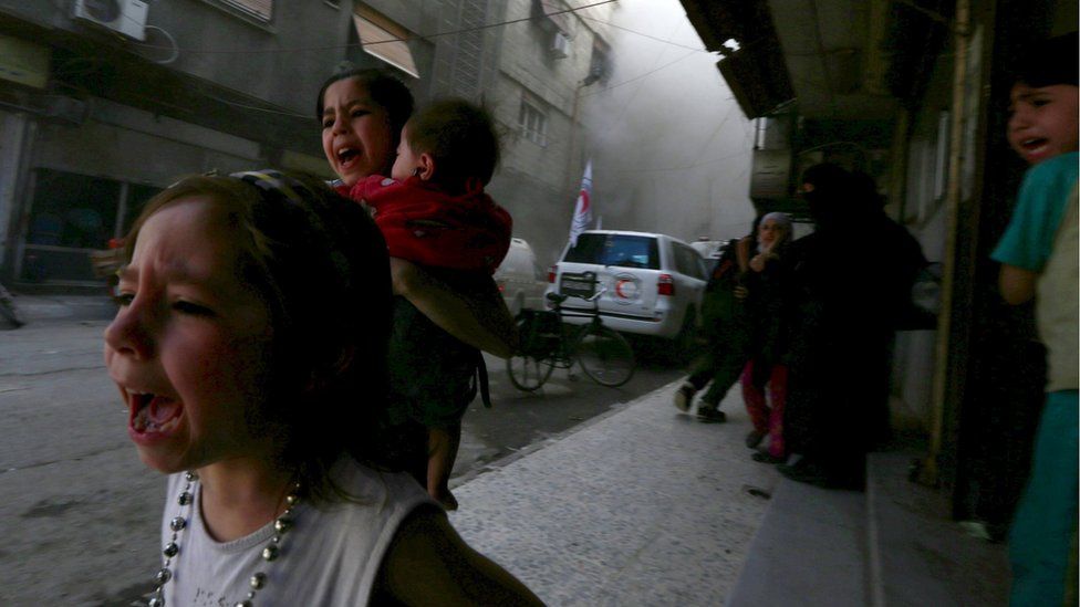 Children fleeing shelling in the Douma neighbourhood of Damascus