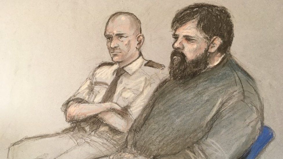 Court sketch of Carl Beech sitting next to a court security man