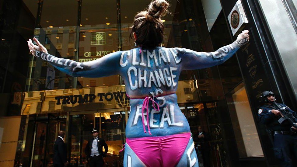 A protester outside Trump Tower declares "climate change is real"