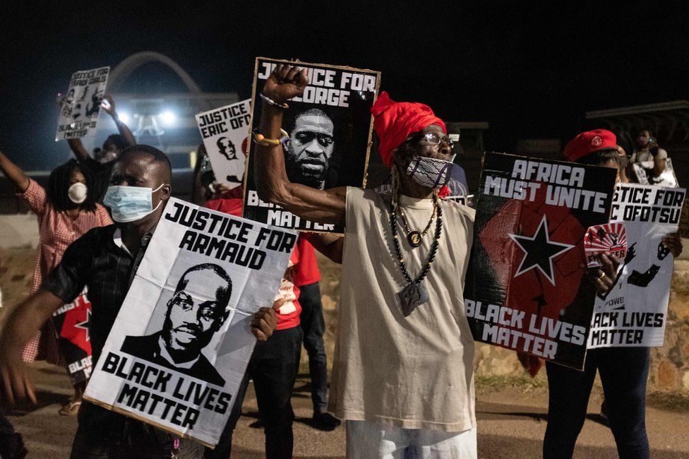 Activists raise their fists in Accra, Ghana on during the protest.