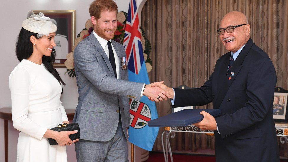 Meghan, Duchess of Sussex and Prince Harry, Duke of Sussex present a gift to the President of Fiji Jioji Konrote