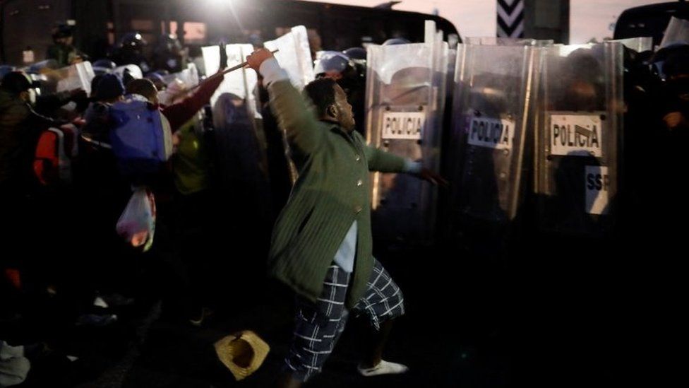 Members of the migrant caravan clash with police, who are preventing them from passing on the Mexico-Puebla highway, in Los Reyes La Paz, Mexico, December 12, 2021