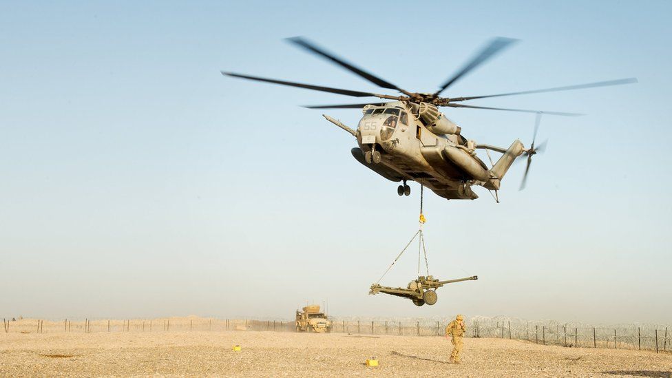 An artillery gun is air lifted out of a British base in Afghanistan by an American helicopter as the base is closed. 8 May 2014.