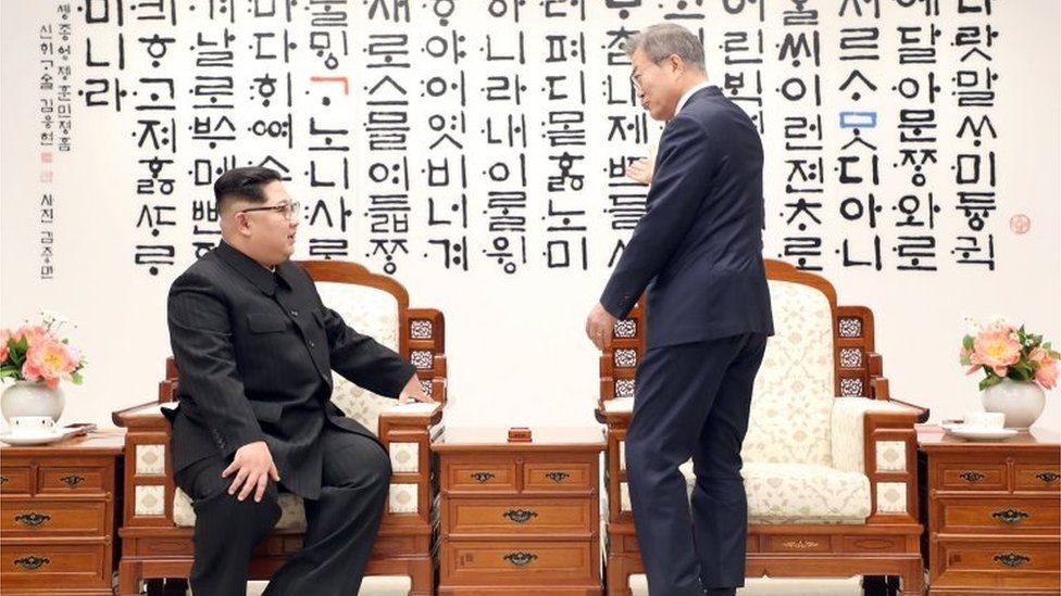 South Korean President Moon Jae-in talks with North Korean leader Kim Jong Un during their meeting at the Peace House