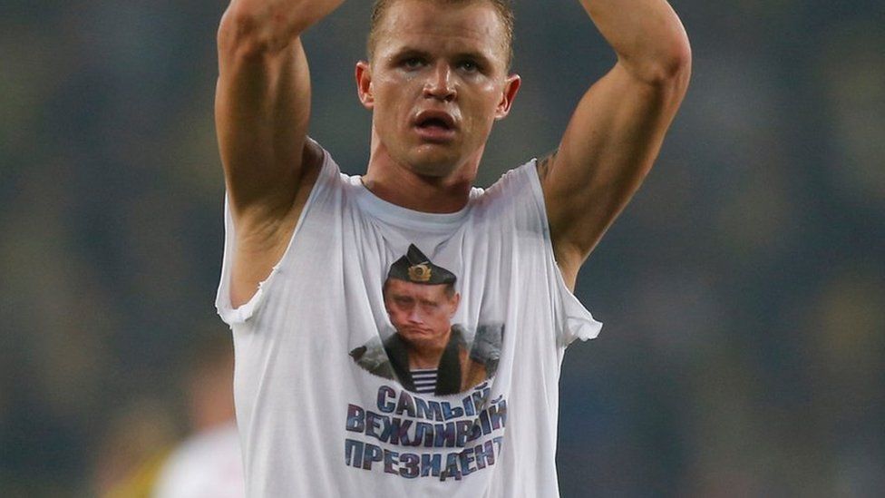 Lokomotiv Moscow's Dmitri Tarasov features an inner shirt with a picture of Russian President Vladimir Putin in Istanbul, Tuesday, Feb. 16, 2016