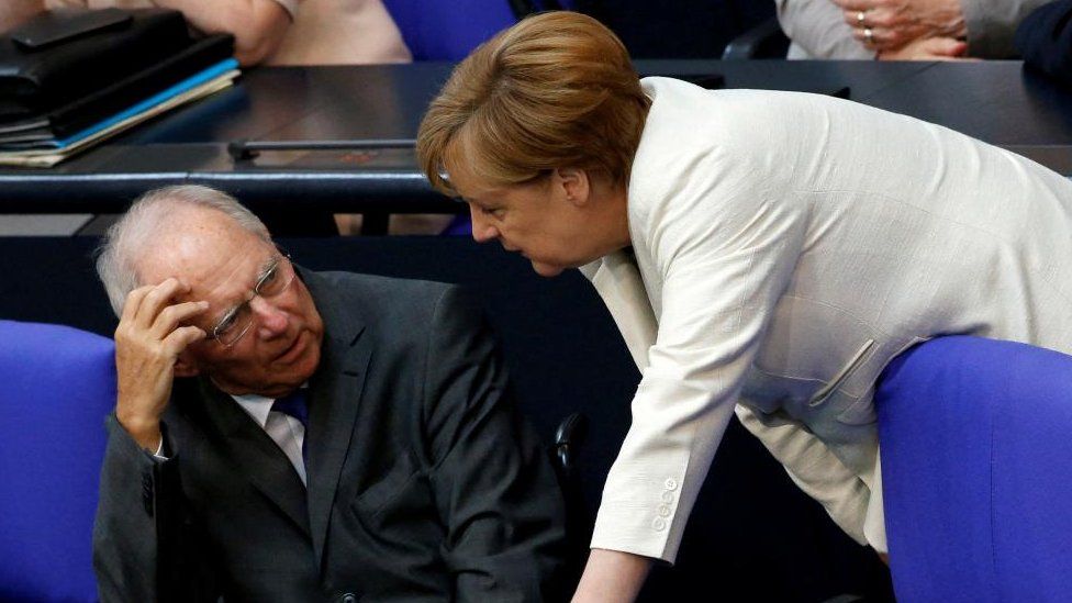German Finance Minister Wolfgang Schaeuble (L) listens to Chancellor Angela Merkel as they attend a debate on the consequences of the Brexit vote at the lower house of parliament Bundestag in Berlin, Germany, June 28, 2016.