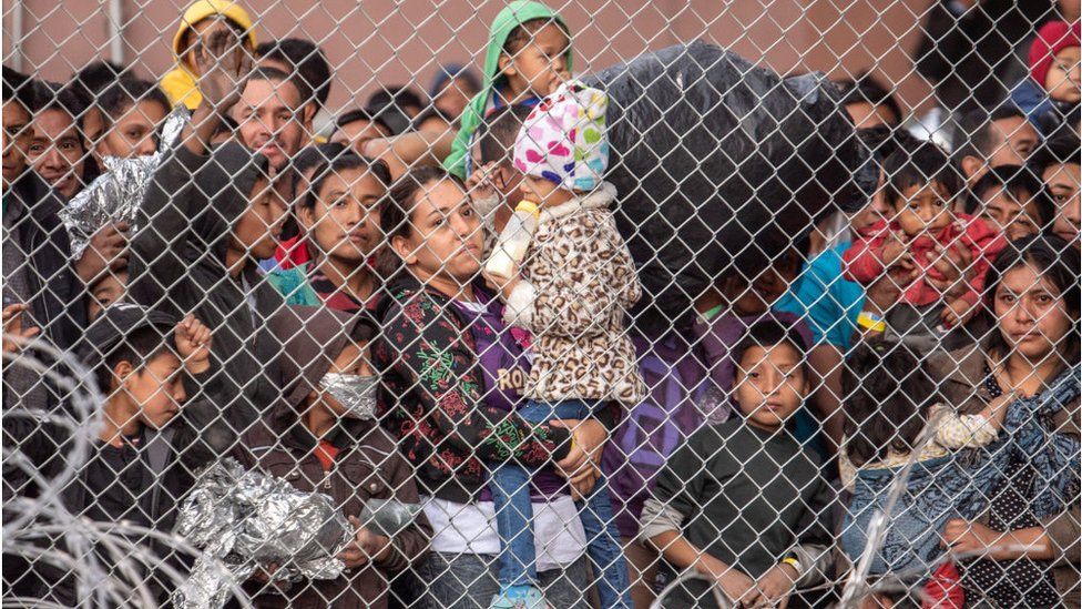 Migrants are gathered inside the fence of a makeshift detention center in El Paso, Texas on Wed. March 27, 2019