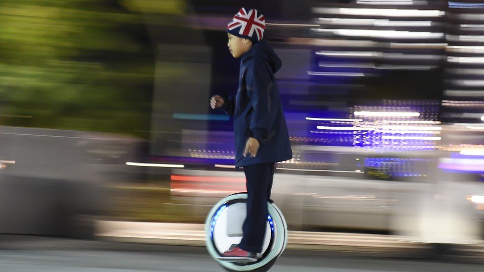 A child rides a one-wheel self-balancing scooter