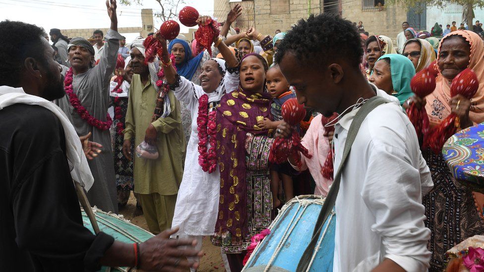 Pakistani devotees of the Sidi ethnic group play traditional music at the shrine of Sufi Hasan-al-Maroof Sultan Manghopir