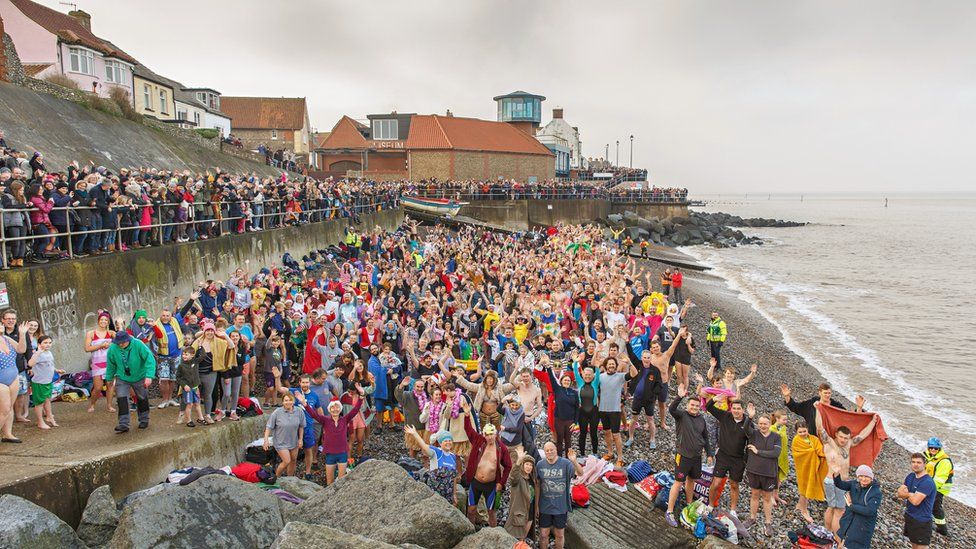 Swimmers pose before launching into the sea at Sheringham, Norfolk in 2020