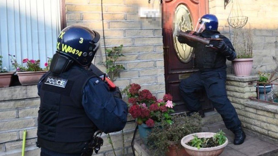 police officers raiding a house