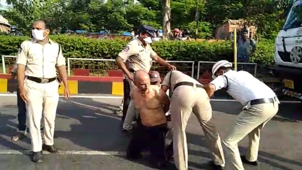 The doctor's hands being tied by the police