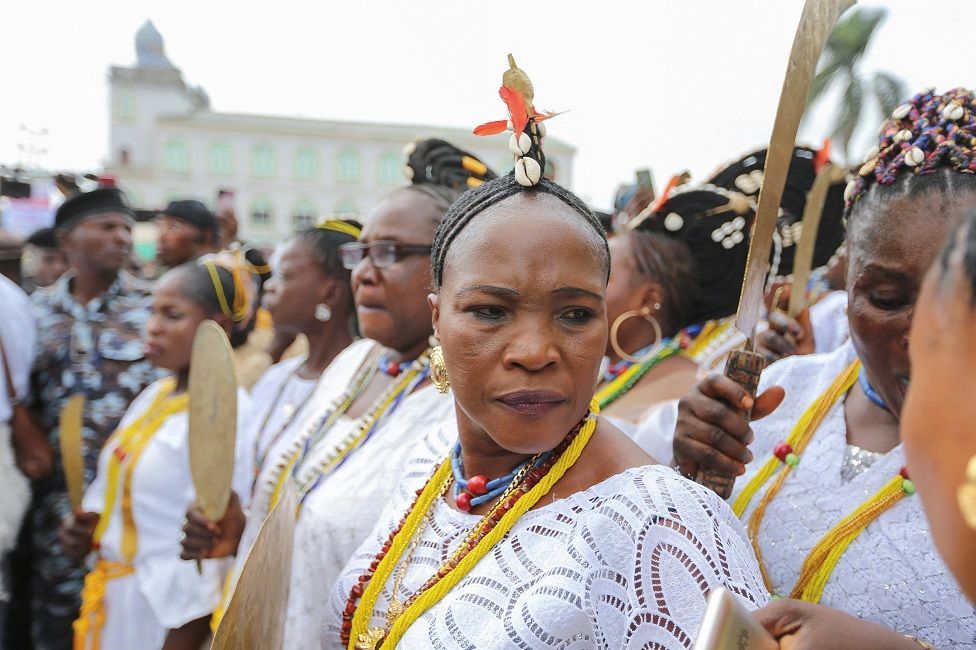 Worshippers of Osun dressed in matching white participate in a procession in Osogbo.