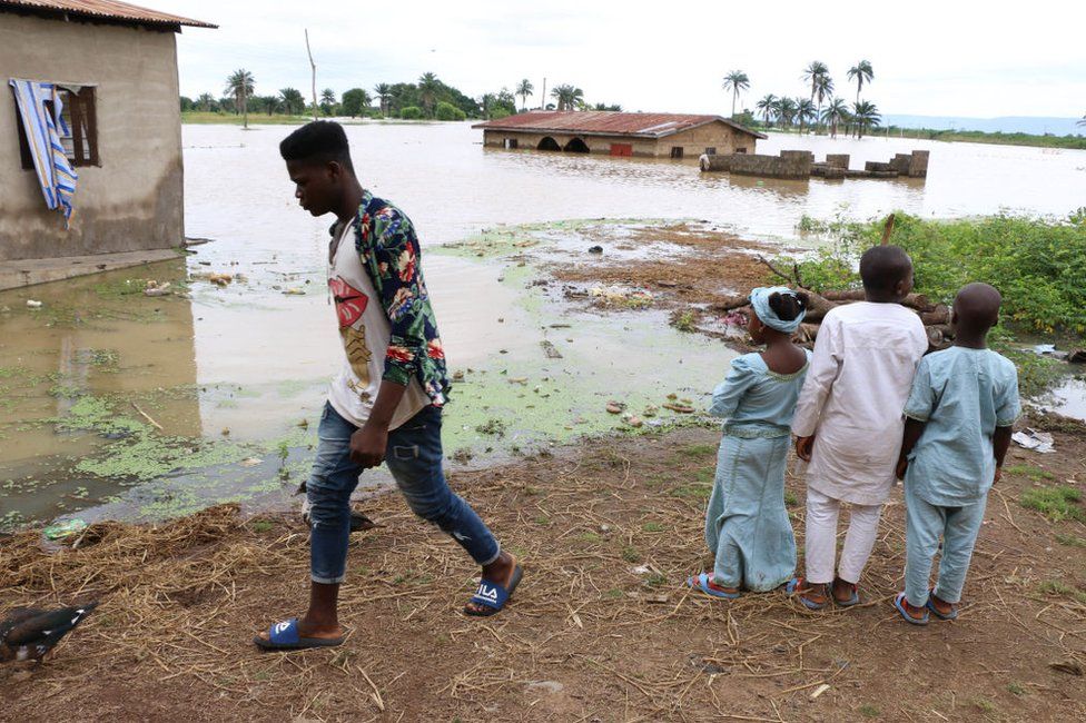 Residents look at the damage following heavy rain in the Nigerian town of Lokoja, in Kogi State, on September 14, 2018.