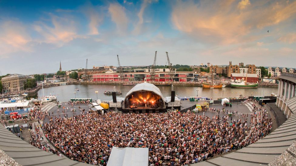 The Bristol Sounds stage at the harbourside in the city, with thousands of people in a large crowd facing the stage