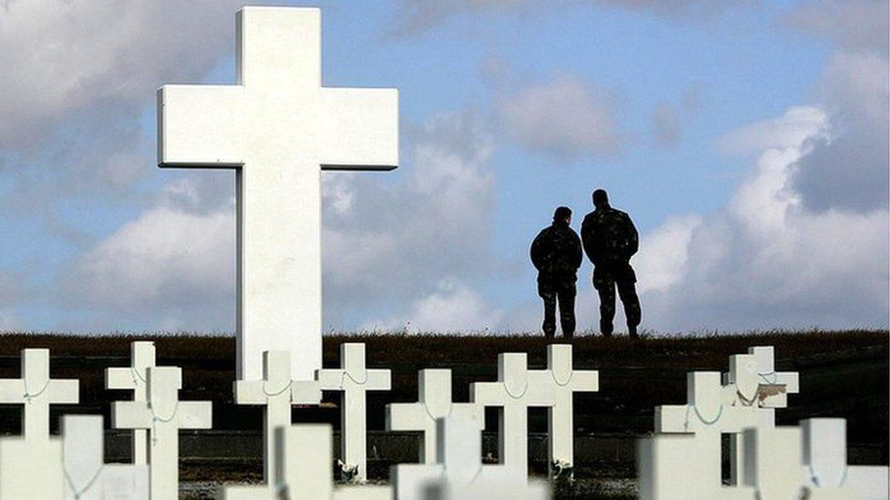 Two members of the British Army looking out over Goose Green from the Argentine memorial cemetery in Darwin on the Falkland Islands