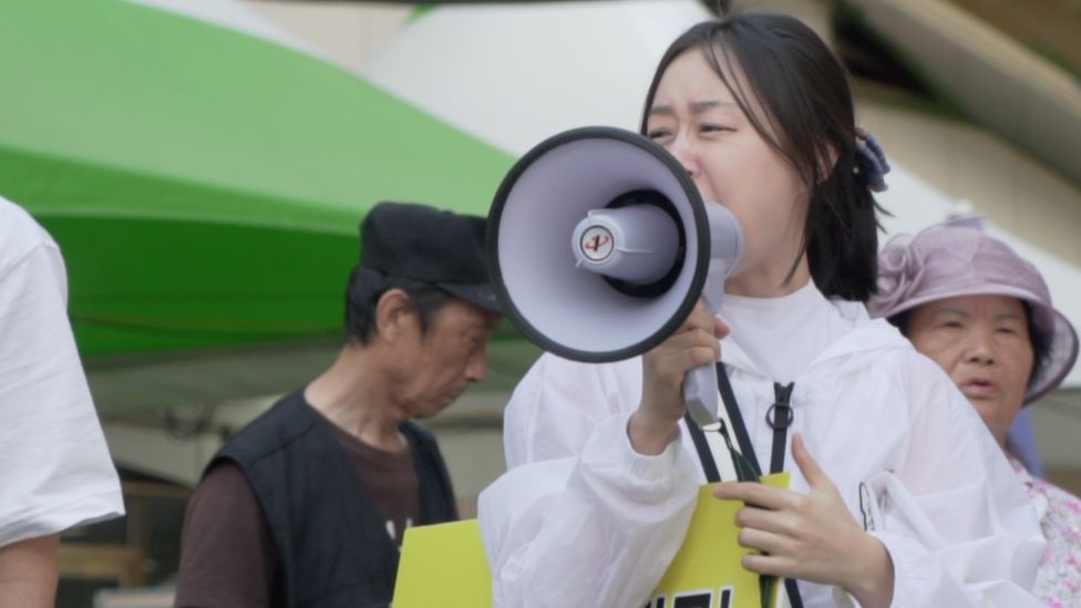 Woman shouts through a megaphone at Incheon Queer Festival