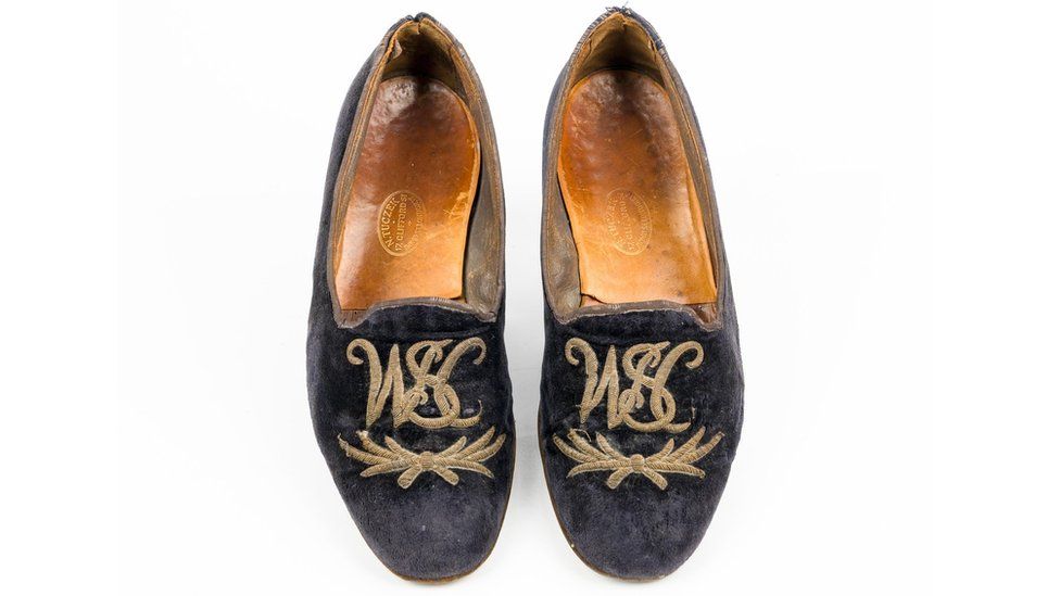 The slippers, showing the embroidered initials